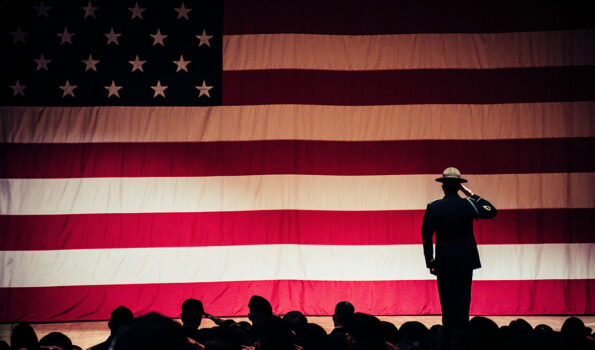 Photo by Brett Sayles: https://www.pexels.com/photo/man-standing-on-stage-facing-an-american-flag-1340504/